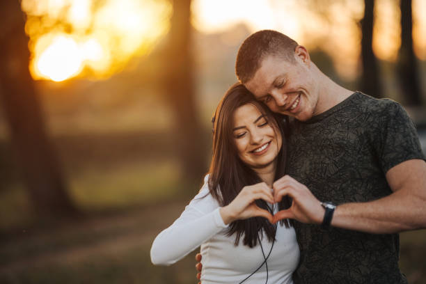 istock Affectionate couple making heart with hands during picnic 1284009880
