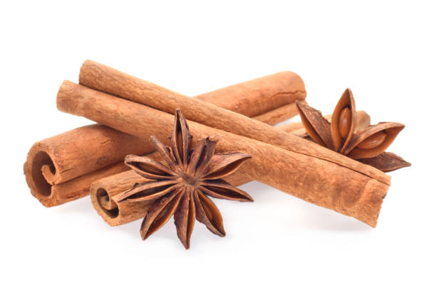 istock Cinnamon sticks and anise stars closed up isolated on white 1284010143