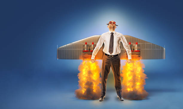 businessman with wings and flares on his back with flames and smoke. businessman with wings and flares on his back with flames and smoke. concept of aspirations and success. start up. turbojet engine photos stock pictures, royalty-free photos & images