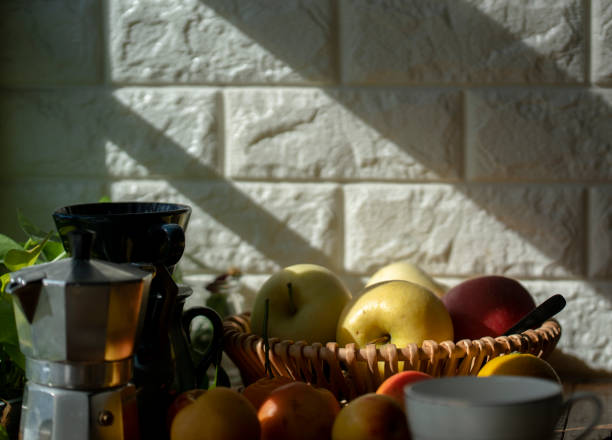 fresh apples and coffee pot in sunlight