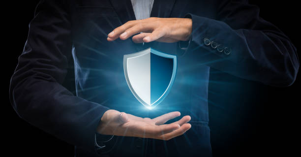 istock Closeup of businessman holding security shield hologram 1284016287