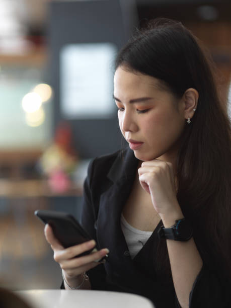istock Businesswoman texting on smartphone while relaxing in office room 1284016559