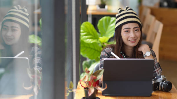 istock Female teenager using digital tablet on her lap while sitting in co working space 1284016594