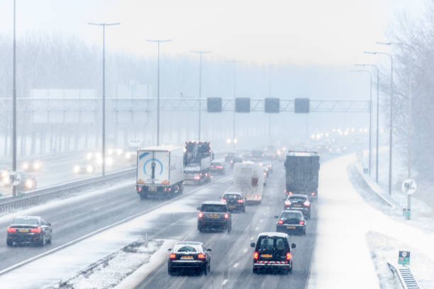 istock Traffic driving on a multiple lane highway during a snow blizzard in winter 1284017626