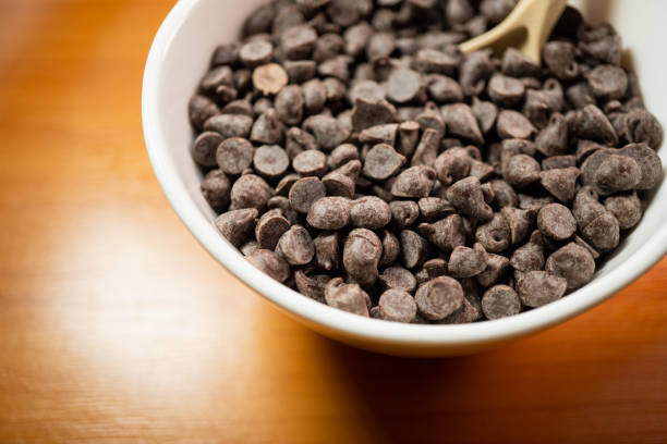 closeup high angle view of chocolate chips in a cup - chocolate white chocolate chocolate chip white imagens e fotografias de stock