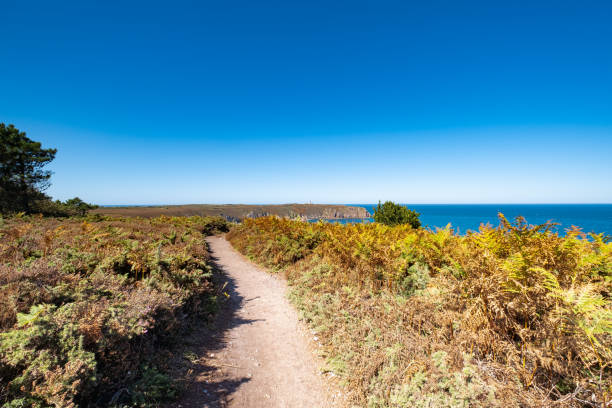 istock ride on the GR34 in Brittany with far off Cape Frehel and its lighthouse 1284019417