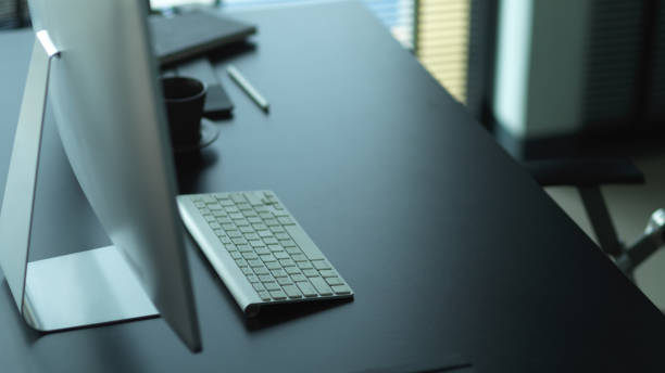 istock Computer desk with supplies and copy space in office room 1284019453
