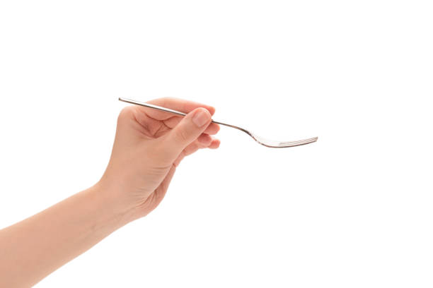 istock Fork in woman hand isolated on white. 1284019490