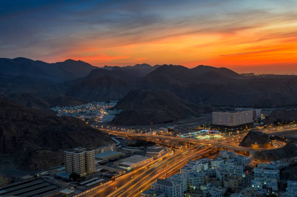 Muscat cityscape in the evening Beautiful Orange sky over Muscat city in the evening. Shot from a hilltop. oman stock pictures, royalty-free photos & images