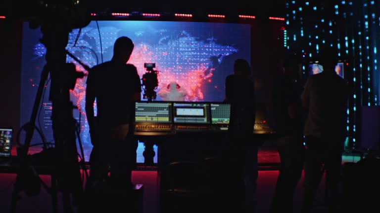 Movie set in silhouettes. Large screen with projection in background