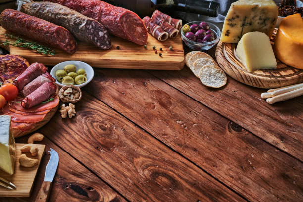 istock Tapas of cured ham and cheese delicious appetizer on rustic wood table with copy space 1284023094