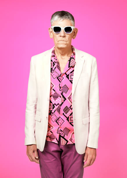 Serious senior man posing on colourful background