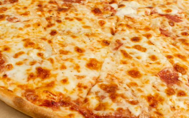 istock Simple Italian Pizza with Cheese Texture Background Closeup 1284025055