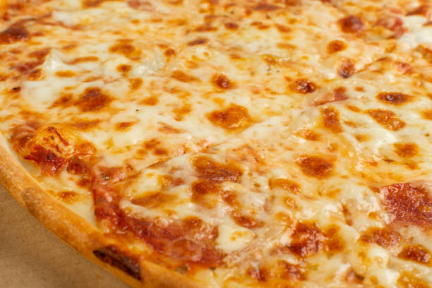 istock Simple Italian Pizza with Cheese Texture Background Closeup 1284025058