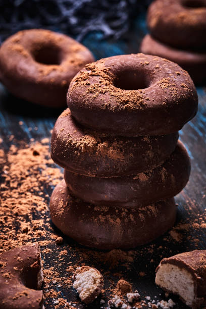 Close-up image of a doughnut like chocolate cookies. Old fashioned style on a bluish rustic table Close-up image of a doughnut like chocolate cookies. Old fashioned style on a bluish rustic table Chocolate Donut stock pictures, royalty-free photos & images