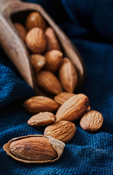 istock Close-up of open Almonds in a group and one into the shell 1284025814