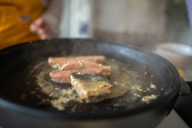Close-up of fish fillet frying at home
