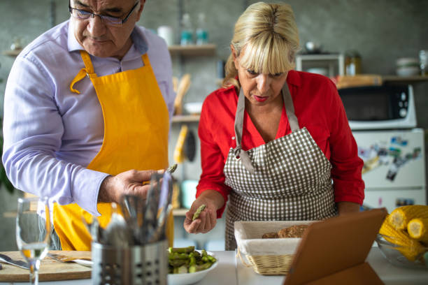 istock Senior couple using technology to find perfect recipe for their meal 1284025965