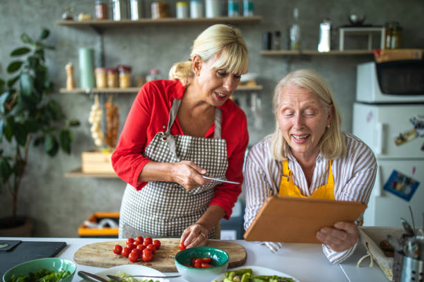 istock Two female senior chefs looking for healthy food recipes using digital tablet 1284025968