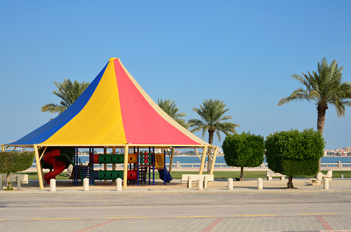 Dammam, Eastern Province, Saudi Arabia: children's park playground, with slides and covered for comfort in the the hot Saudi weather - Dammam corniche - Khaleej Road / Arabian Gulf Road