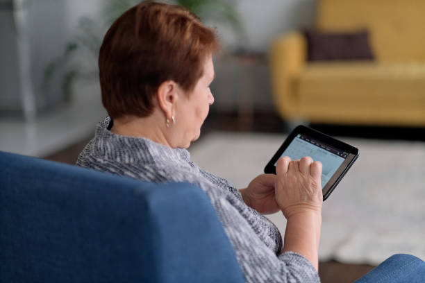 istock Senior Indian Woman Using Digital Tablet At Home 1284027291