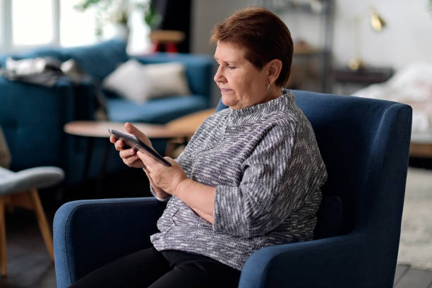 istock Senior Indian Woman Using Digital Tablet At Home 1284027299