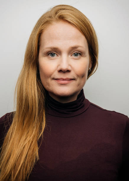 istock Confident redhead woman against white background 1284027445