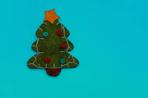 istock Christmas composition. Green felt tree on a blue background. Copy space. New Year 2021. Handmade. 1284031848