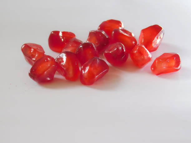 istock closeup view of pomegranate seeds isolated on white background 1284032706