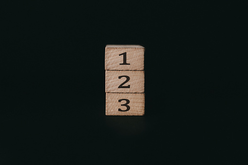 Wooden alphabet number blocks 123 on black background