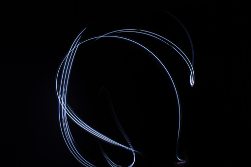 blue parallel lines pattern against a black background. Light painting photography