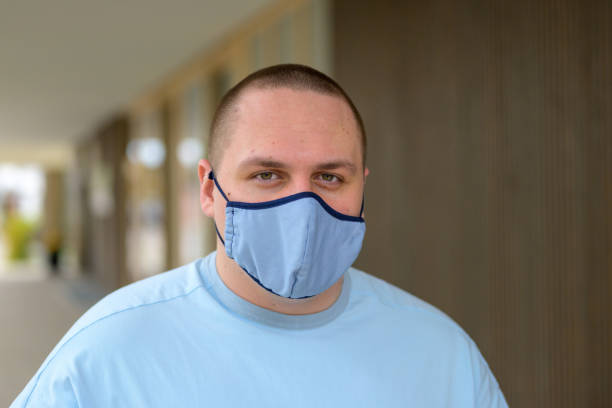 istock Young man in town wearing a face mask 1284037194
