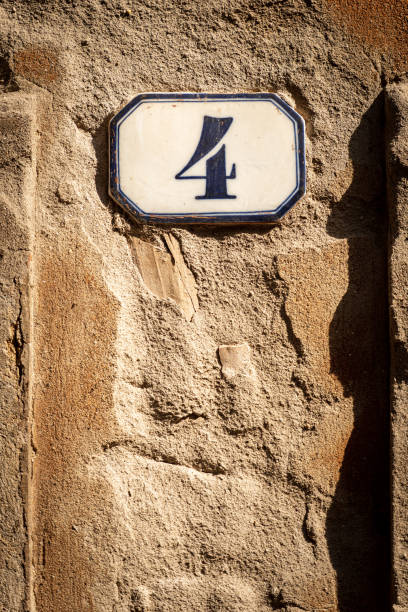 House Number 4 on a Broken Wall - Verona Italy Close-up of house number 4 (four) on a broken wall, Verona city, Veneto, Italy, southern Europe. ceramic tile house numbers stock pictures, royalty-free photos & images
