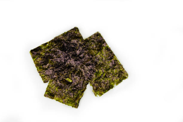 Crispy nori seaweed Crispy nori seaweed isolated on white background. Japanese Traditional japanese dry seaweed sheets. nori edible seaweed sheet stock pictures, royalty-free photos & images