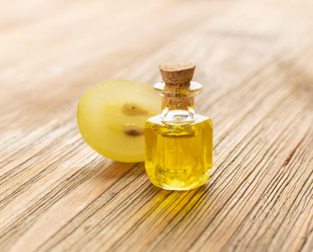 istock Grape Oil Seed in Small Vintage Bottle on Wooden Rustic Background 1284038663