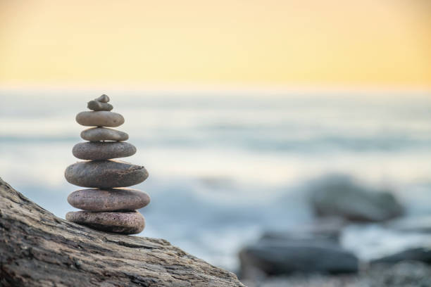 istock Zen balanced stones stacked on sea coast at sunset. 1284038814
