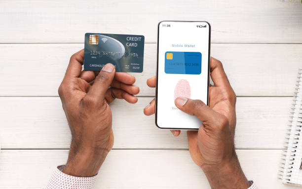 istock Man Holding Card And Phone With Mobile Wallet App 1284039978