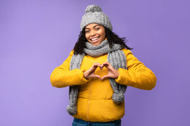 istock Cheerful Black Woman Gesturing Heart Shape Posing Over Purple Background 1284040401