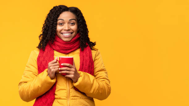 istock African Lady In Jacket Enjoying Coffee Posing On Yellow Background 1284041181