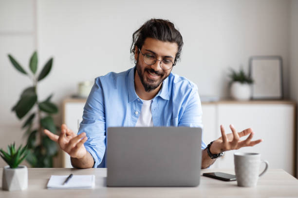 istock Video Conference. Friendly man office employee in headset having call on laptop 1284041414