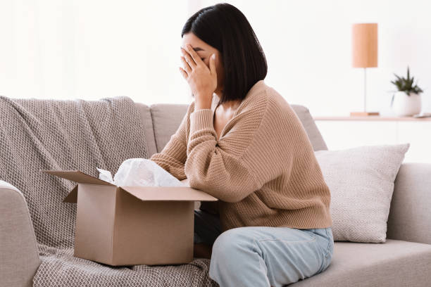 istock Sad young woman unpacking wrong parcel, delivery mistake 1284041523