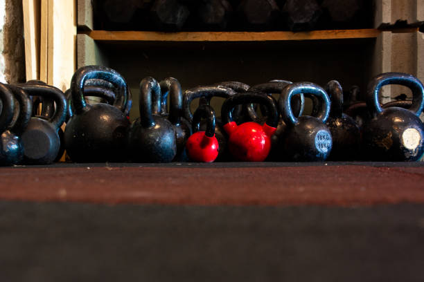 Set of kettlebells on gym floor, various size and color