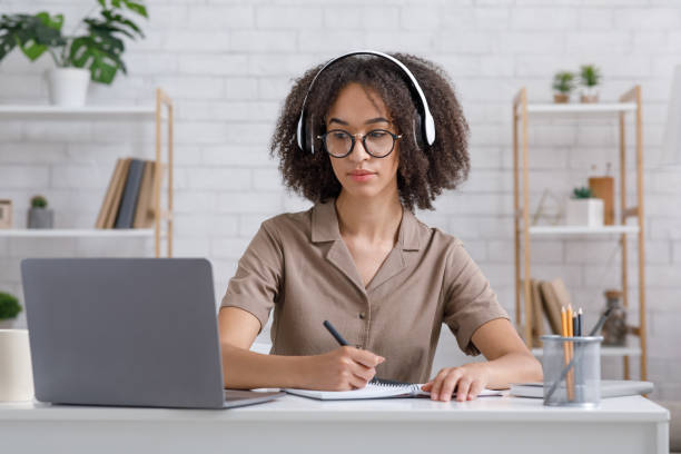 istock Self-education, online lecture and webinar remotely. Concentrated african american lady in glasses 1284043838