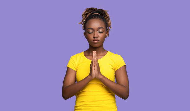istock Young black woman showing clasped hands in pleading gesture 1284044329