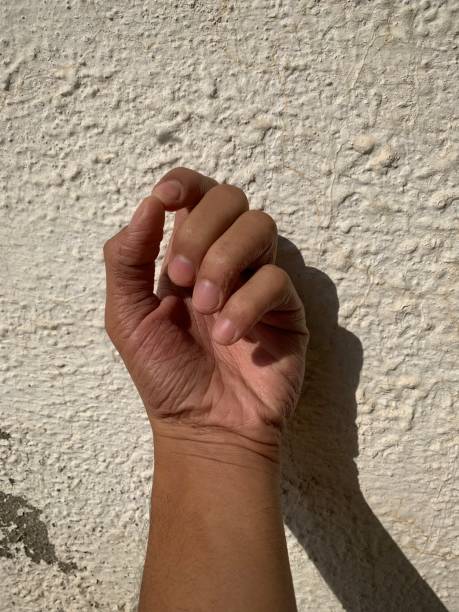 istock Fist on a teenager against a textured white wall 1284045697