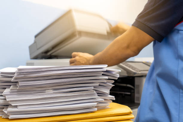 The papers stacked waiting to be copied with a copier machine. The papers stacked waiting to be copied with a copier machine. flat bed scanner stock pictures, royalty-free photos & images