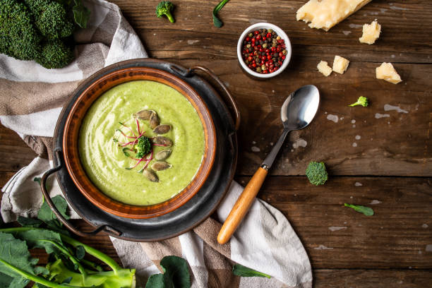 istock Spring detox broccoli green cream soup with microgreen, pumpkin seeds on rustic background, banner, catering menu recipe place for text, top view 1284046949