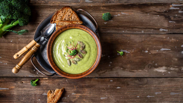 istock Delicious broccoli cream soup in a bowl with toasted bread. Copy space. Long banner format, top view 1284047166