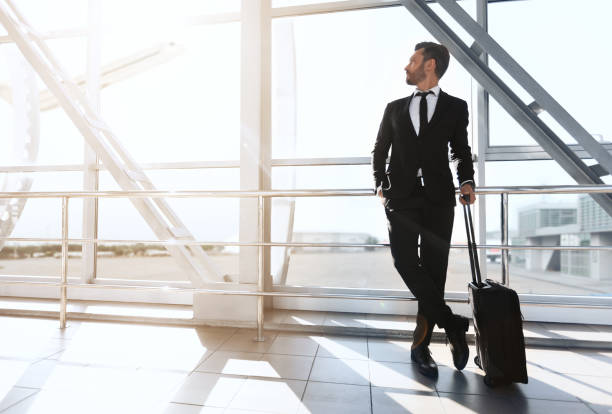 istock Successful businessman standing next to window at airport 1284048799