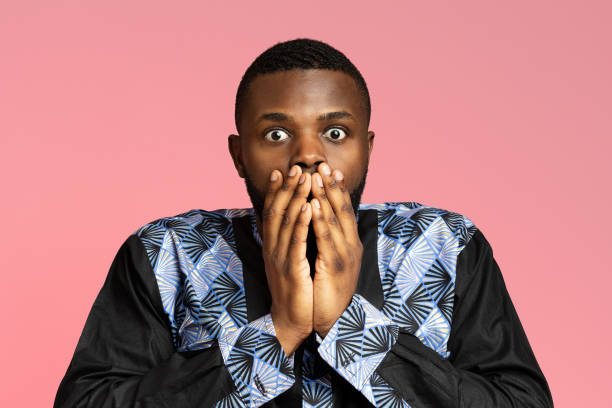 istock Shocked african american guy covering his mouth 1284048944